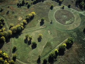 Image is of an aerial photo the Medicine Wheel Earthwork on the Haskell Indian Nations University Campus, created by students, faculty, tribal elders, and Stan Herd, photograph by Jon Blumb